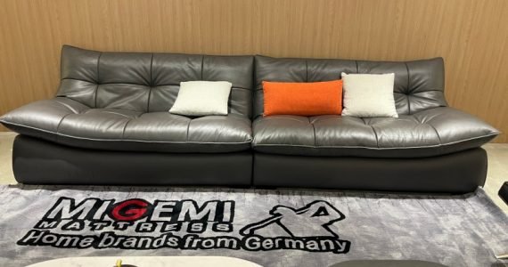 grey soft leather sofa with pillows